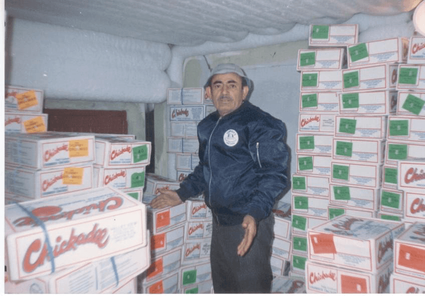 Haris Stamboulidis unloading a container stacked with Chickadee boxes
